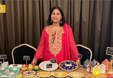 Deepti Tripathi, Indian folk artist, smiling warmly in front of her traditional artwork